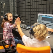 RJs high-fiving each another at the radio station